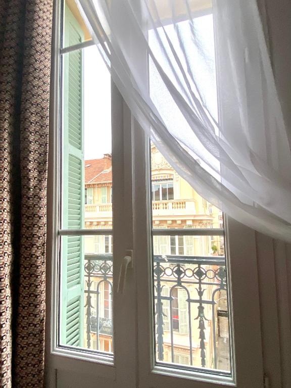 a window with a view of a city at Hotel Solara in Nice