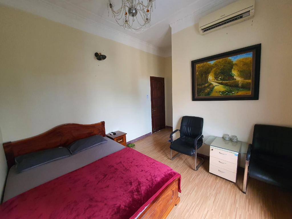 Postel nebo postele na pokoji v ubytování Khách sạn Hoàng Anh