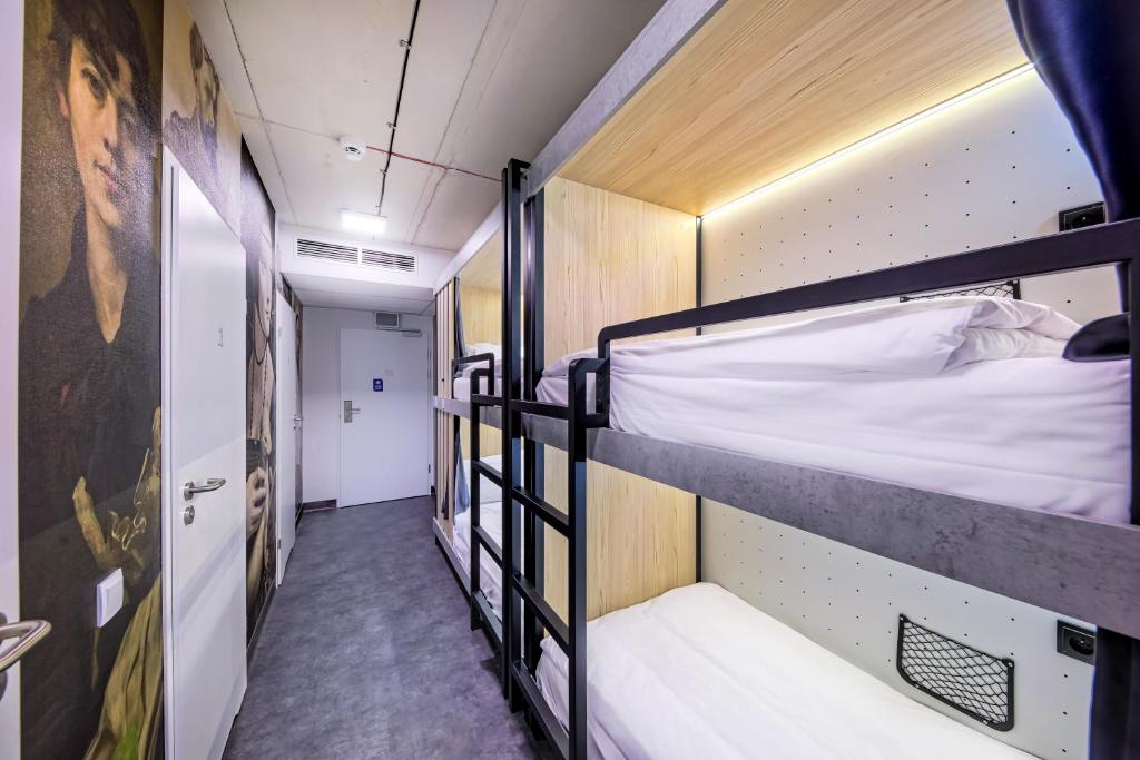 a hallway with two bunk beds in a room at Easy One Premium Art in Krakow