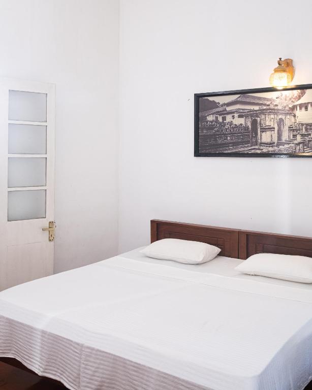 Postel nebo postele na pokoji v ubytování Fortuna Heritage Home