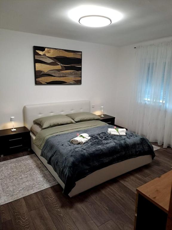 a bedroom with a large bed and two night stands at Dedin dvorac in Valpovo