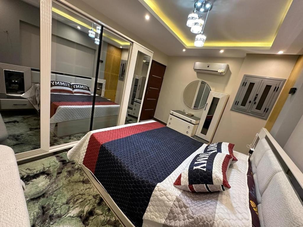 a hospital room with a bed and a mirror at Elegant SeaView Apartment in Alexandria