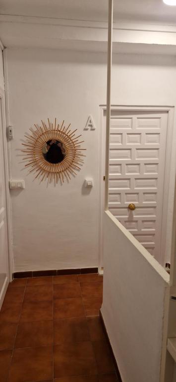 a hallway with a door with a mirror on the wall at La casa de Martin in Marchena