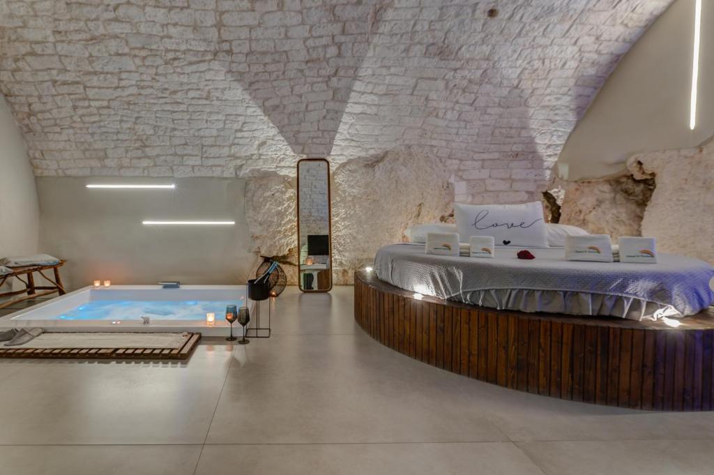 a bedroom with a bed and a swimming pool at MALOLÙ luxurysuite in Ostuni