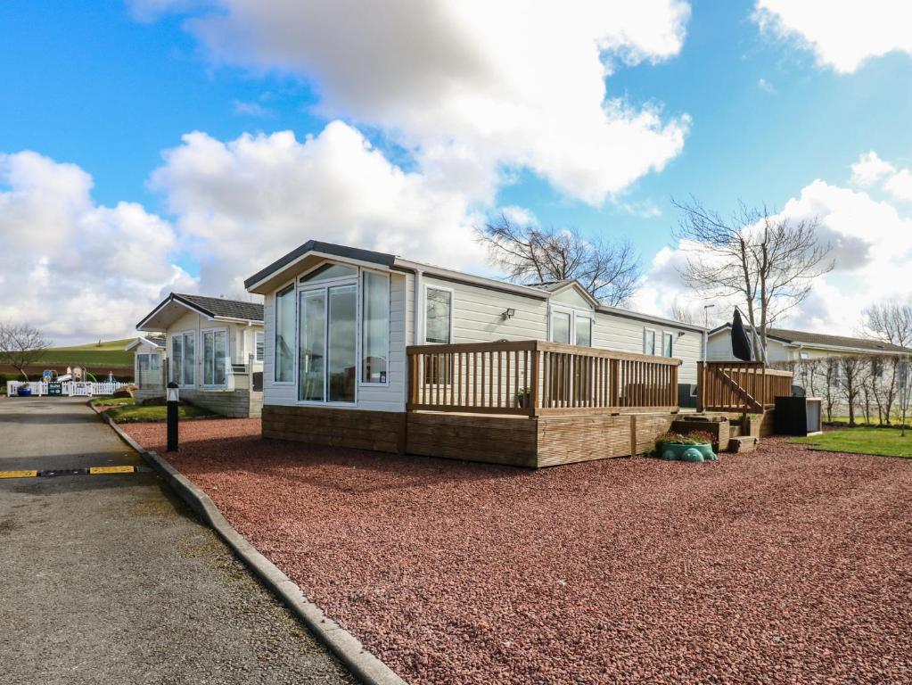a white house with a porch and a deck at New Horizon in Carlisle
