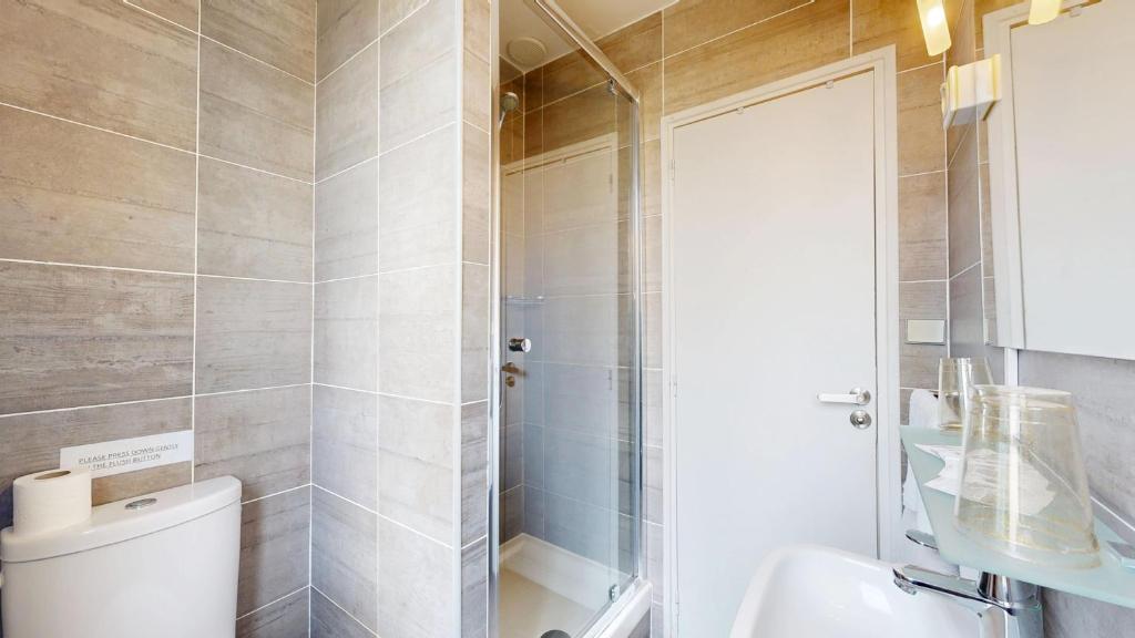 a bathroom with a toilet and a shower at Hotel Solara in Nice