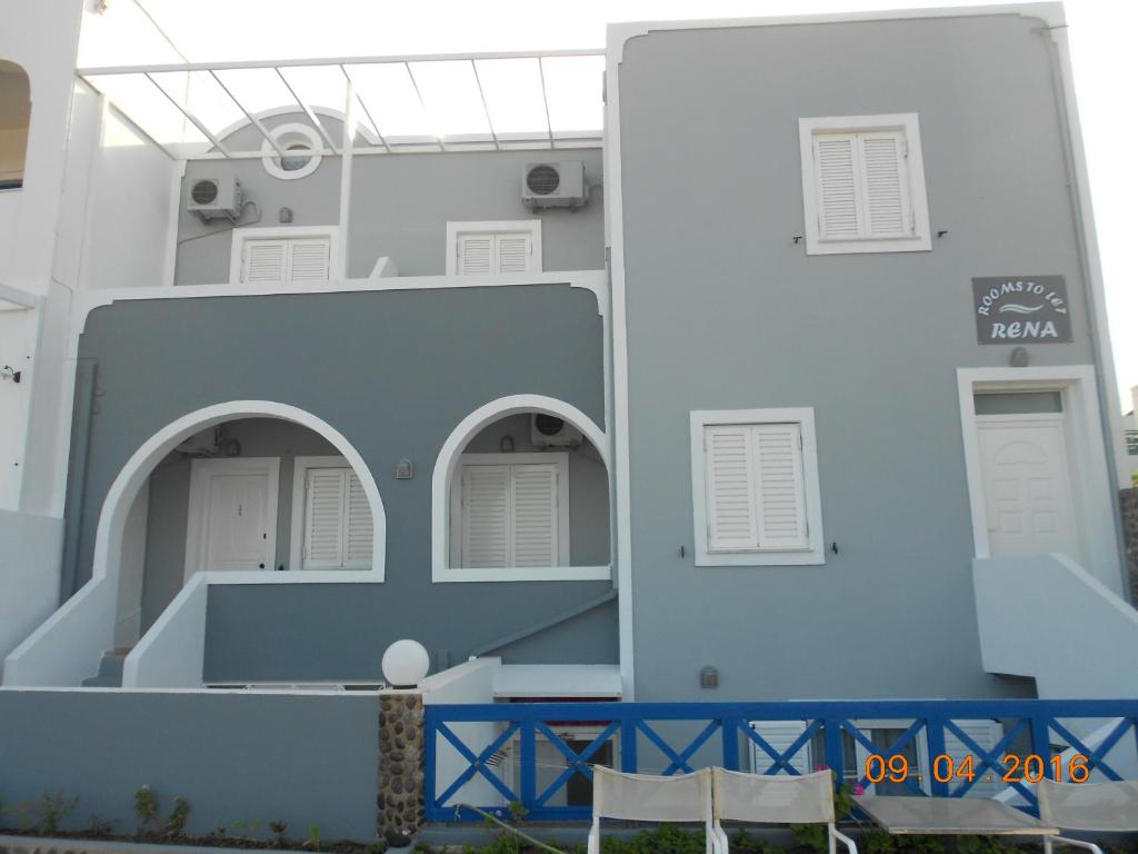 a white building with two arched windows on it at Rooms to let Rena in Monolithos