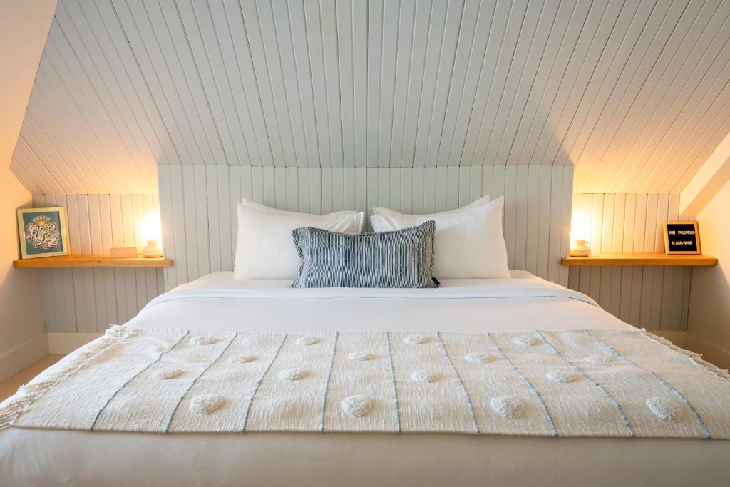 a bedroom with a large bed with two pillows at The August House in Windsor