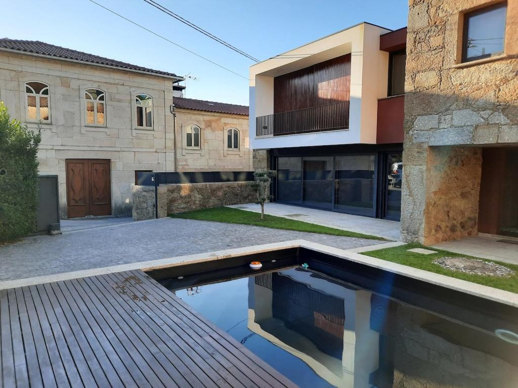 a house with a swimming pool in front of it at O Refúgio - Gerês in Souto