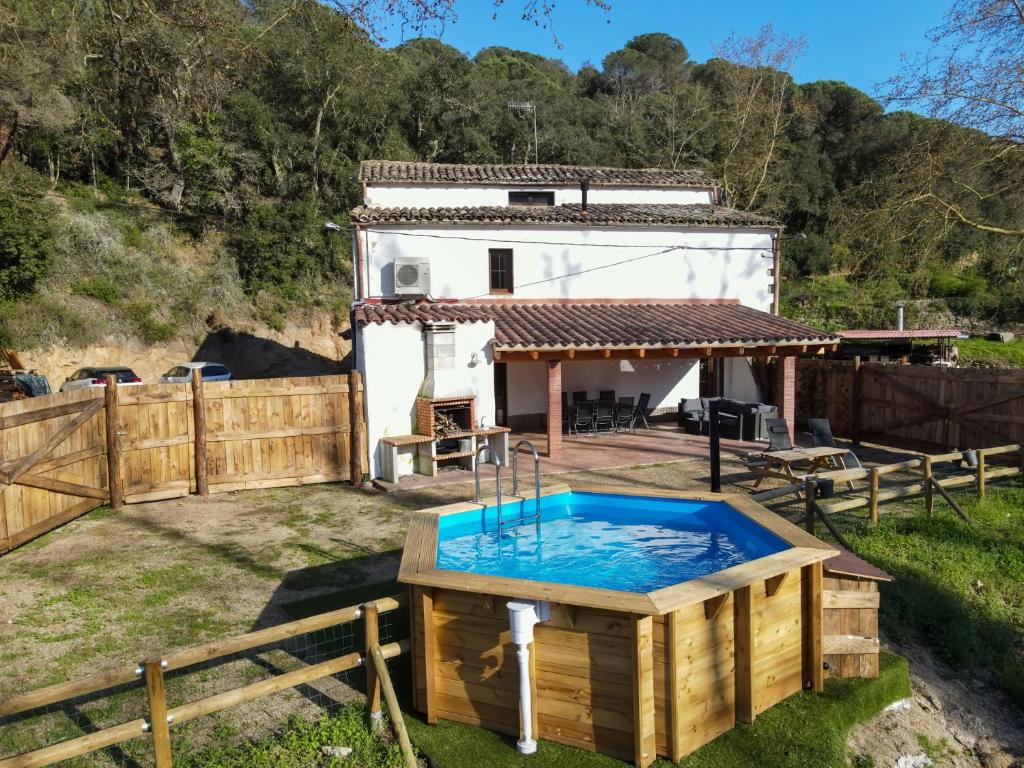 a house with a hot tub in a yard at Casa Rural Can Ricós - El Mirador del Montseny in Vallgorguina