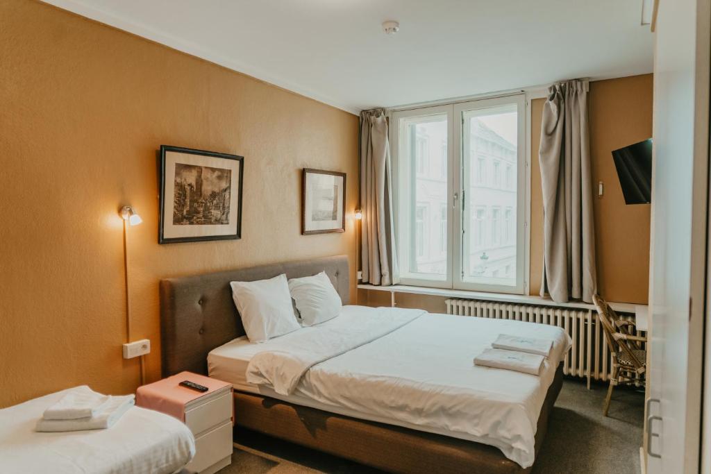 Postel nebo postele na pokoji v ubytování Hotel Cavalier