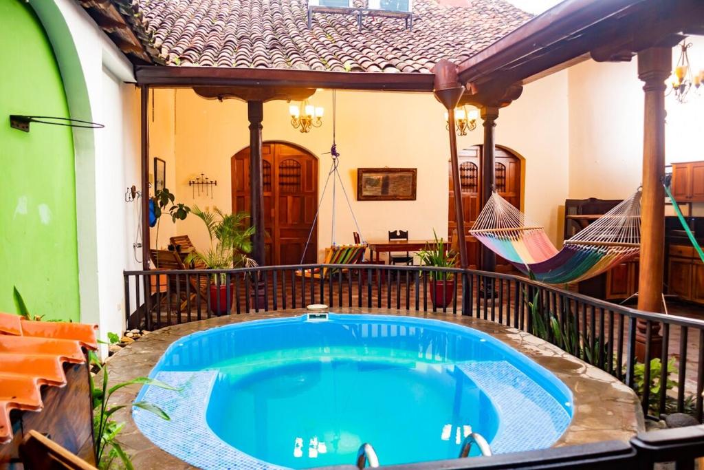 a swimming pool in the middle of a house at Elegant, Romantic & Kid-Friendly Colonial Home in Granada