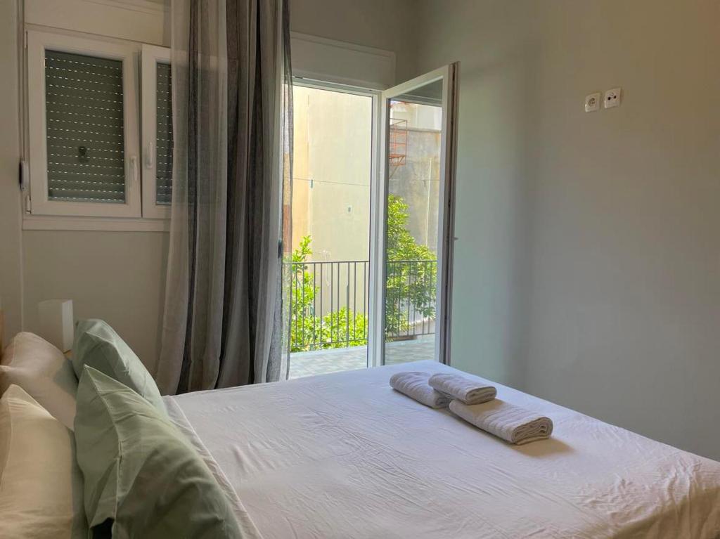 a bedroom with a bed with two towels on it at Center Twin Apartments - 2 in Chios