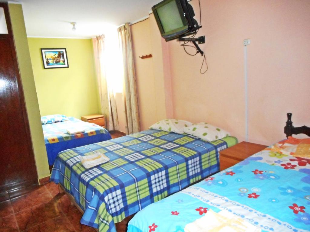 Postel nebo postele na pokoji v ubytování Hostal Geminis