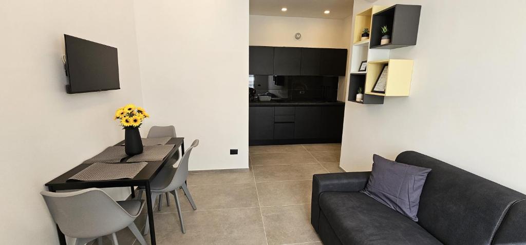 a living room with a couch and a table with chairs at Golden Moon in Lido di Ostia