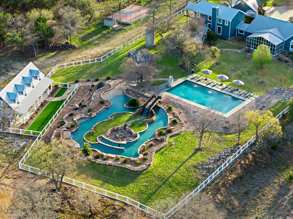 an aerial view of a swimming pool with a resort at Lazy River Ranch - Lazy River Pool, Golf & Pickleball in Kreutzberg