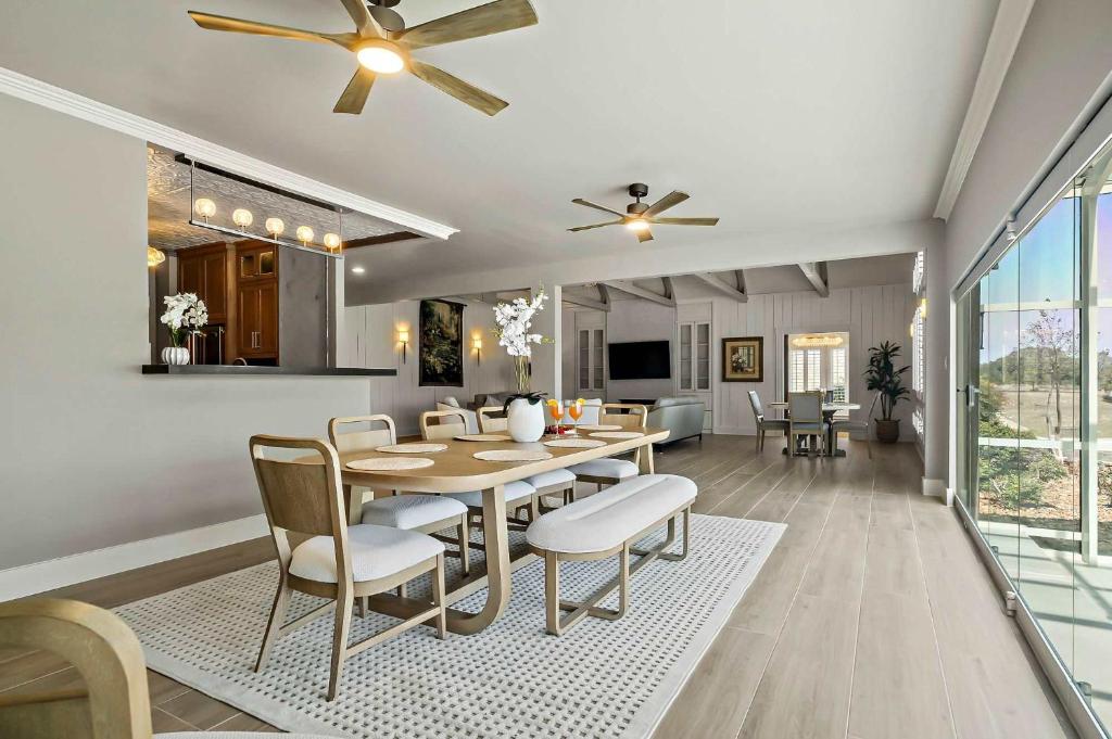 a dining room and living room with a table and chairs at Lazy River Ranch - Lazy River Pool, Golf & Pickleball in Kreutzberg