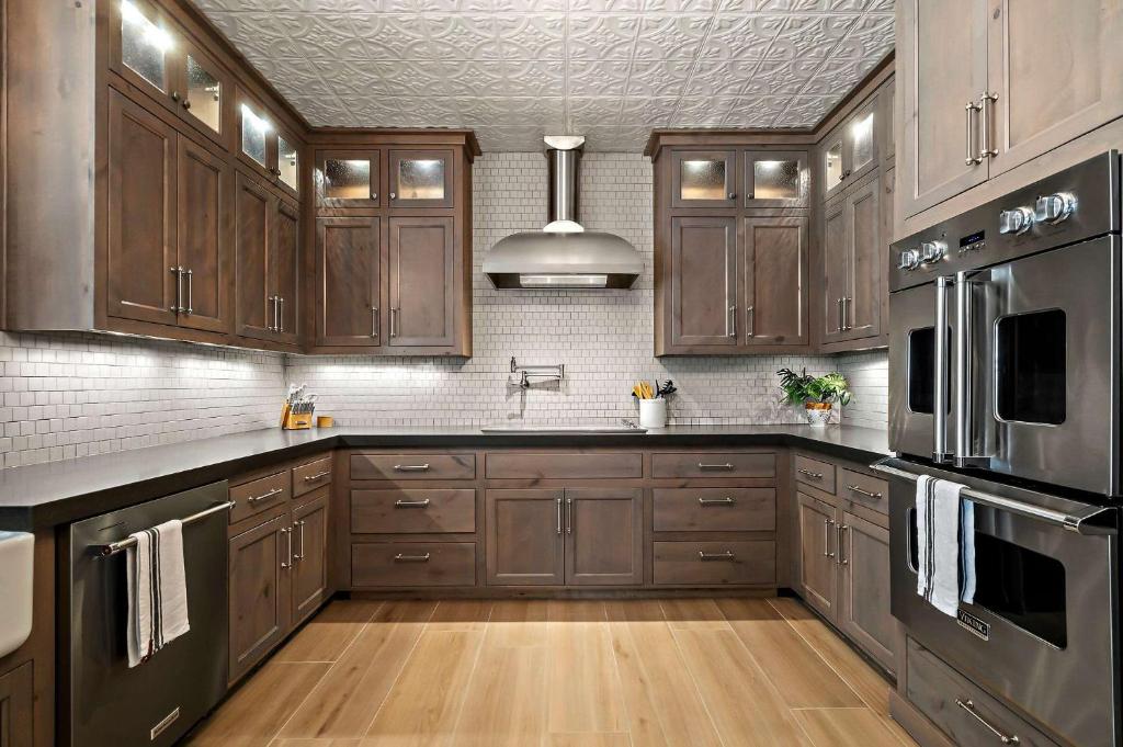 a kitchen with wooden cabinets and a stainless steel appliance at Lazy River Ranch - Lazy River Pool, Golf & Pickleball in Kreutzberg