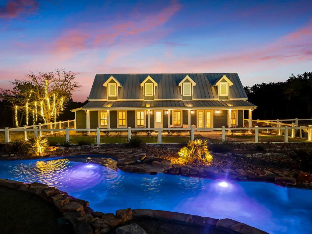 a house with a pool in front of it at night at Lazy River Ranch - Lazy River Pool, Golf & Pickleball in Kreutzberg