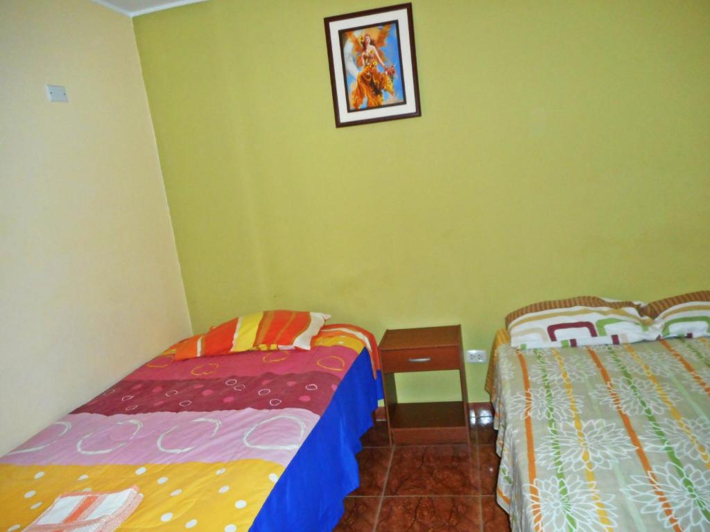 Postel nebo postele na pokoji v ubytování Hostal Geminis