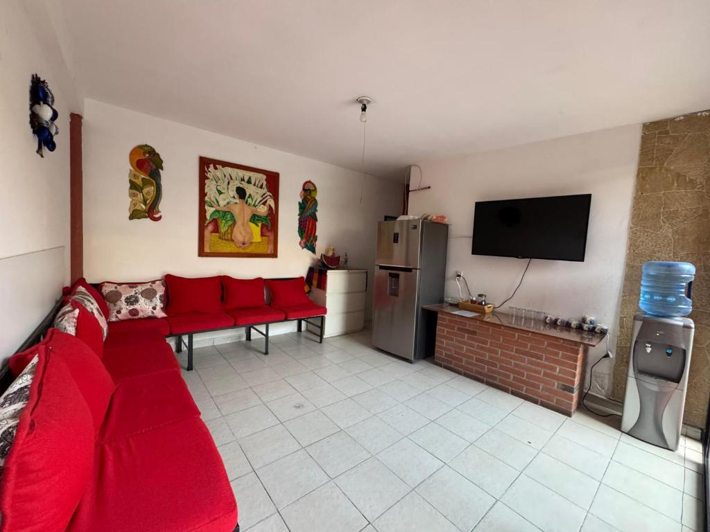 un soggiorno con un divano rosso e una TV di México Lindo a Città del Messico