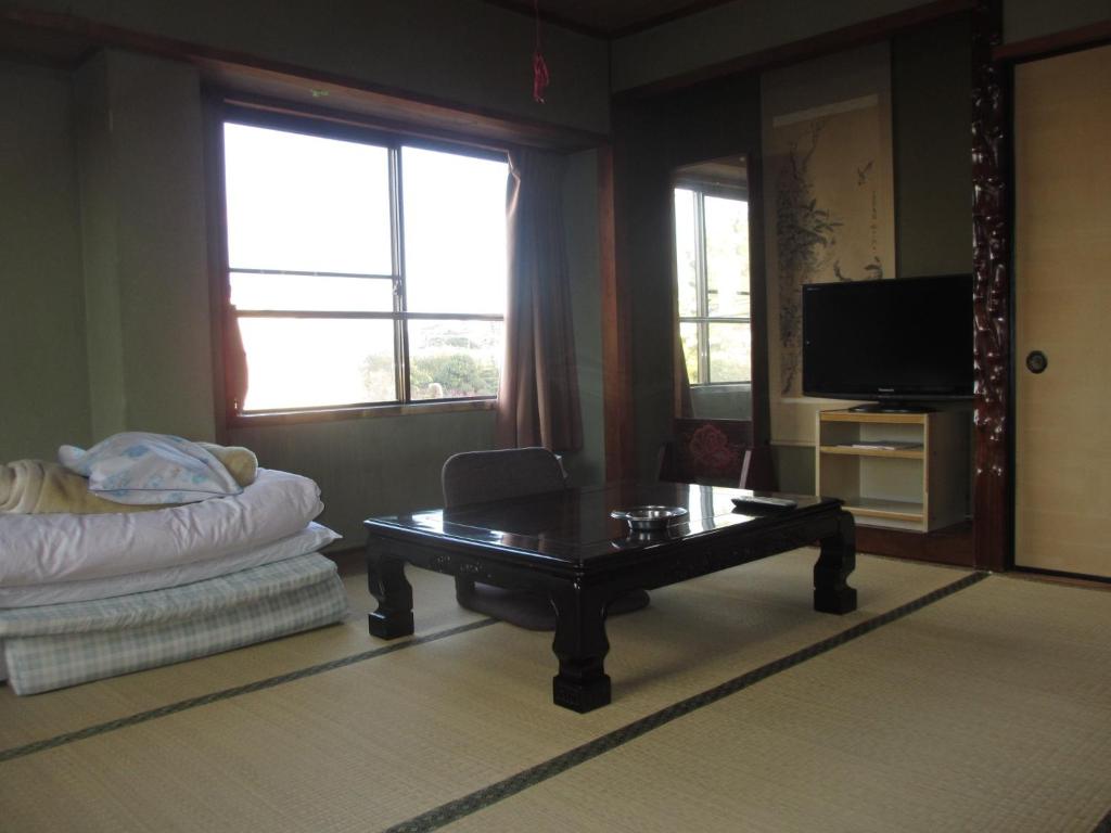 a living room with a coffee table and a couch at Ogawaya Ryokan - Vacation STAY 87447v in Tahara