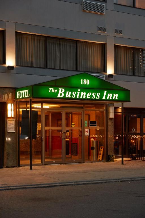 a hotel with a sign that reads the business inn at The Business Inn in Ottawa