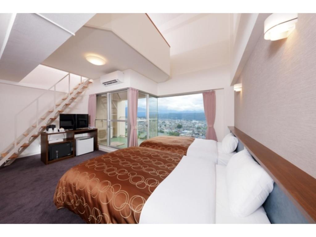a hotel room with a bed and a large window at Natural Farm City Noen Hotel - Vacation STAY 78838v in Chichibu