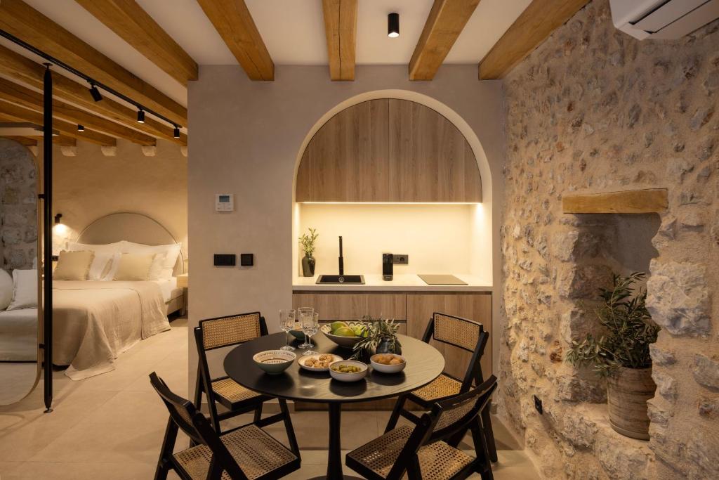 a room with a table and chairs and a bed at Old Town Olive Studio Apartment in Dubrovnik
