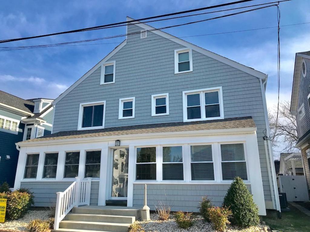 a gray house with a white front porch at Maryland avenue 58 #6 in Rehoboth Beach