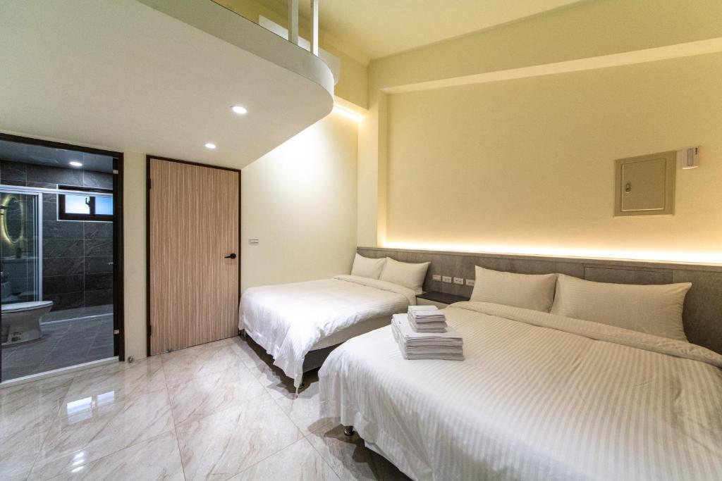 Postel nebo postele na pokoji v ubytování Langchao B&B