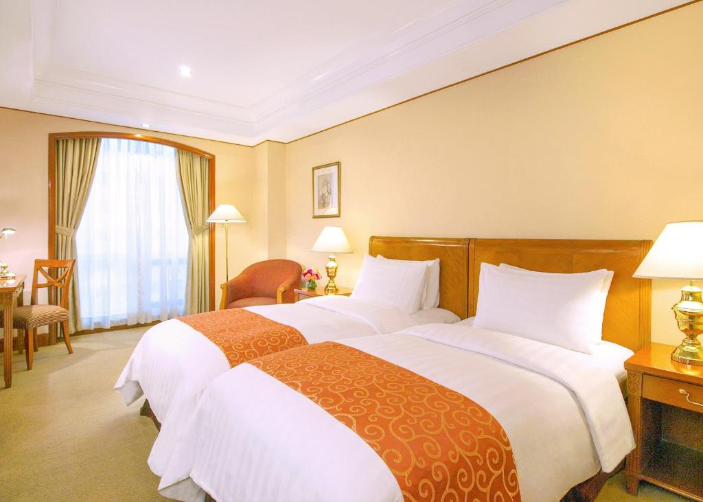 Postel nebo postele na pokoji v ubytování Richmonde Hotel Ortigas, Manila