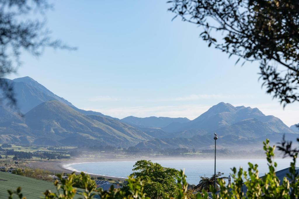 a view of a beach with mountains in the background at Private, Peaceful, Handy Location - KK7832 in Kaikoura