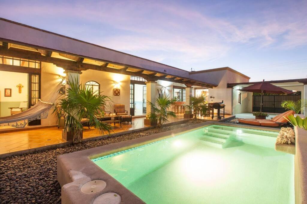a swimming pool in the backyard of a house at private Pool, walk to malecón, 2 BR estilo hacienda in La Paz