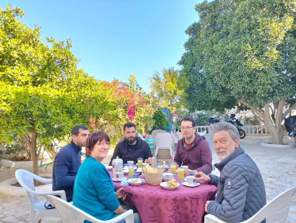 a group of people sitting around a table eating at Henchir ejdoud in Kairouan