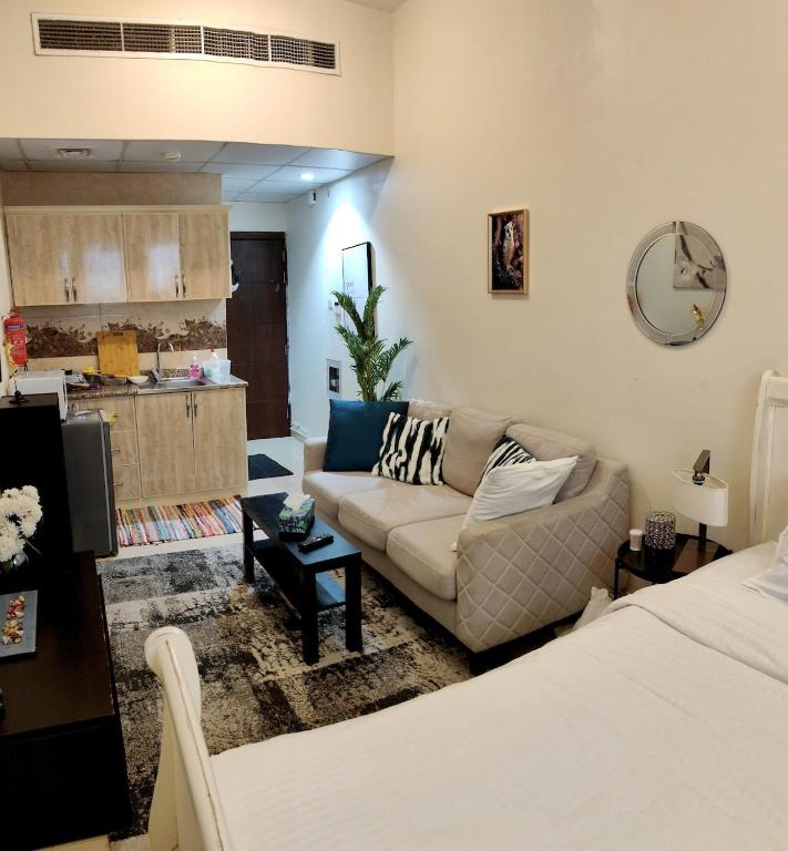 ein Wohnzimmer mit Couch und Küche in der Unterkunft Rare find Dubai in Dubai
