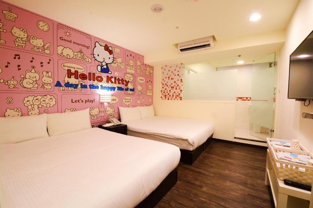 a room with two beds and a hello kitty wall at Sleep Taipei in Taipei