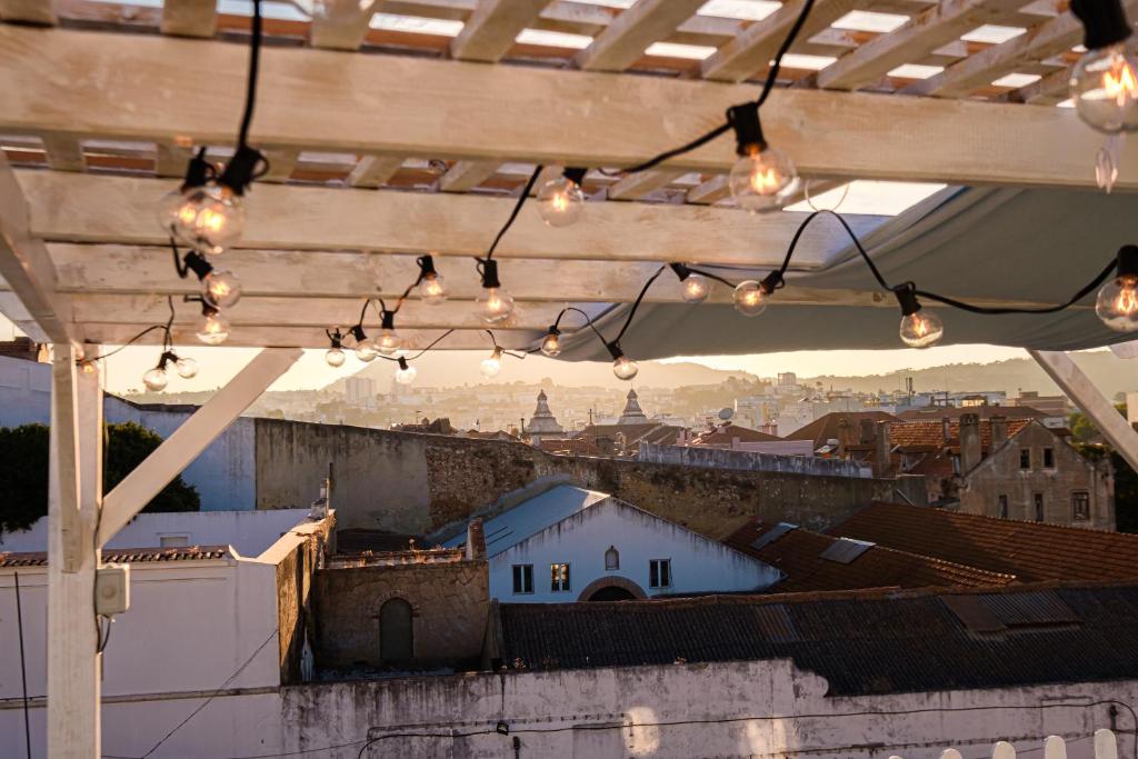 a view of a city from a rooftop with lights at Y Quebedo - Boutique Apartments in Setúbal