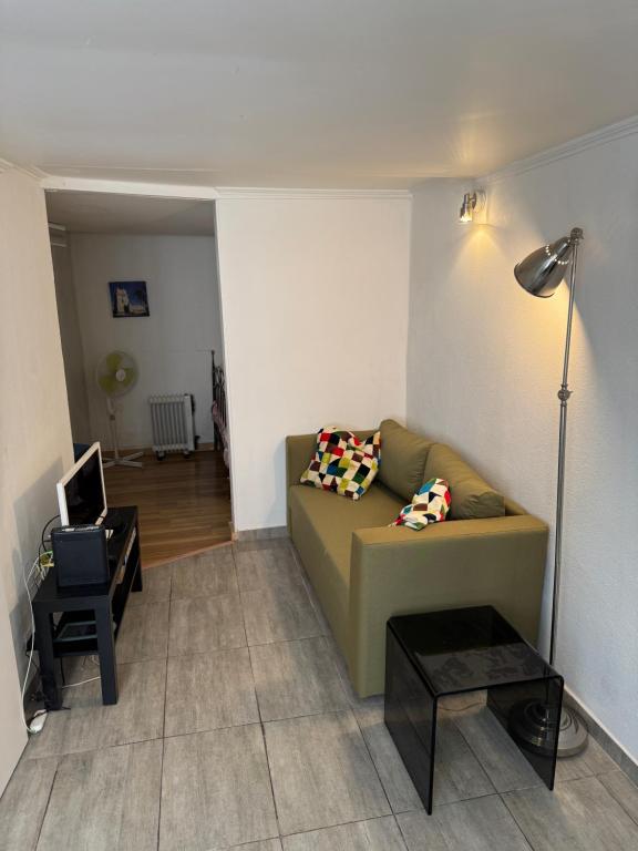 a living room with a couch and a table at Lisbon Secret & Graca Apartment in Lisbon