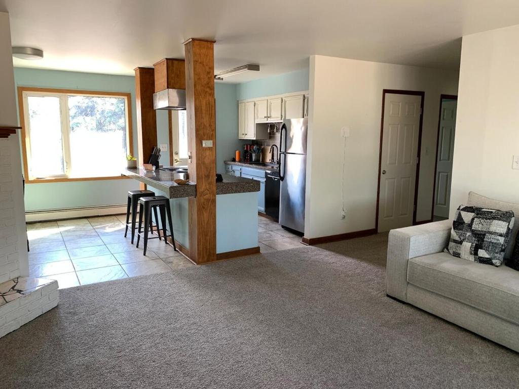 a kitchen and living room with a couch and a table at Two Bedroom in Great Location in Fairbanks