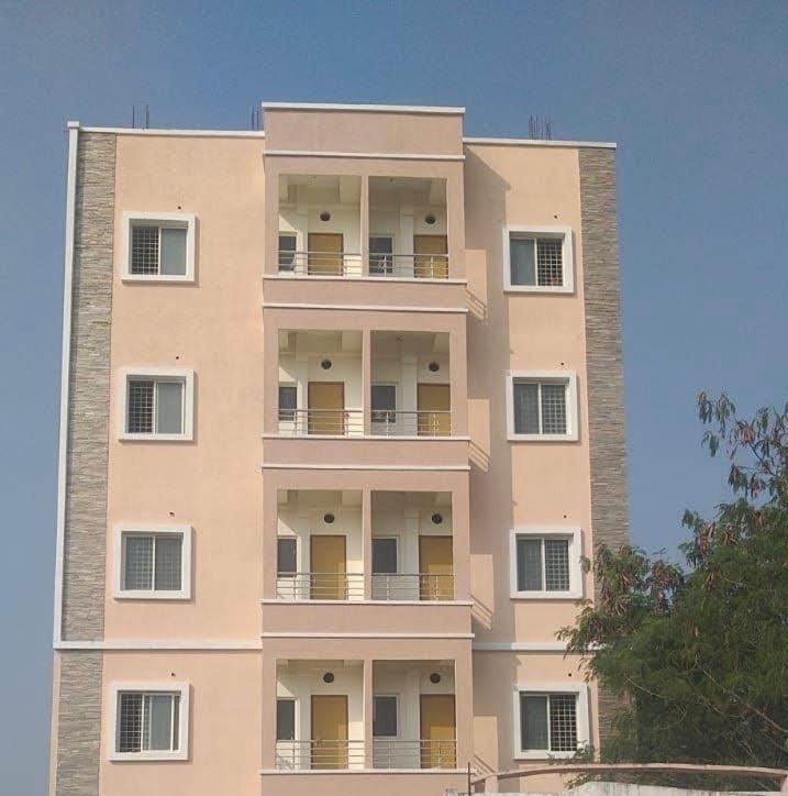 a tall building with balconies on the side of it at Mannat Enclave in Haidar Sāhibgūda