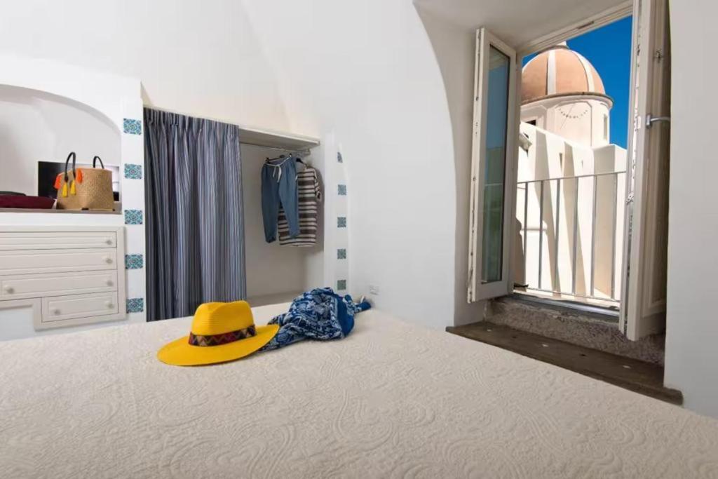 a yellow hat sitting on the floor of a room at La Dolce Vita By Fantasy in Forio d'Ischia
