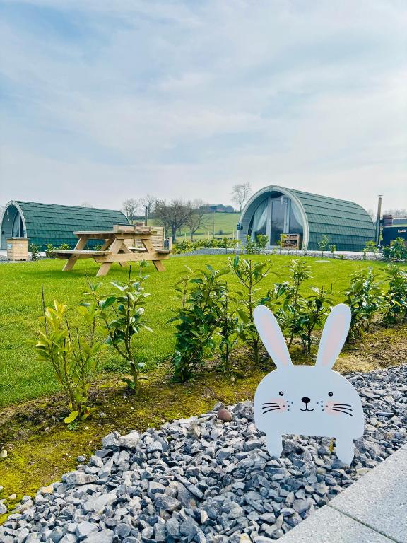 a statue of a bunny on the gravel in a park at Knockmany View Glamping in Augher