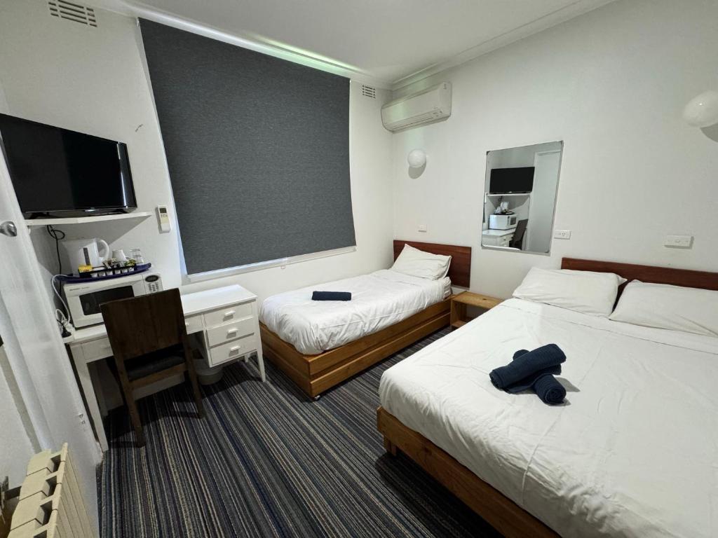 Postel nebo postele na pokoji v ubytování Bunkhouse Motel Cooma