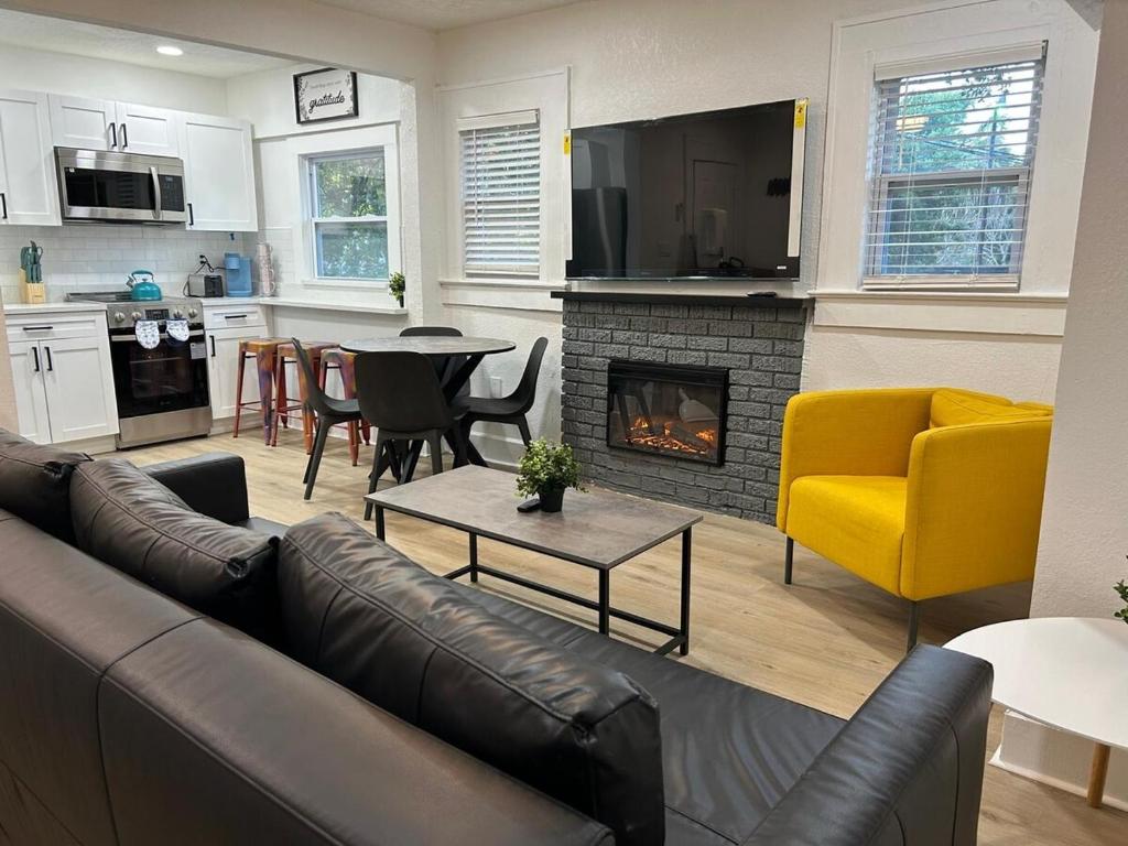 a living room with a couch and a fireplace at Downtown Zen 2-Bedrooms Private Bungalow in St Petersburg
