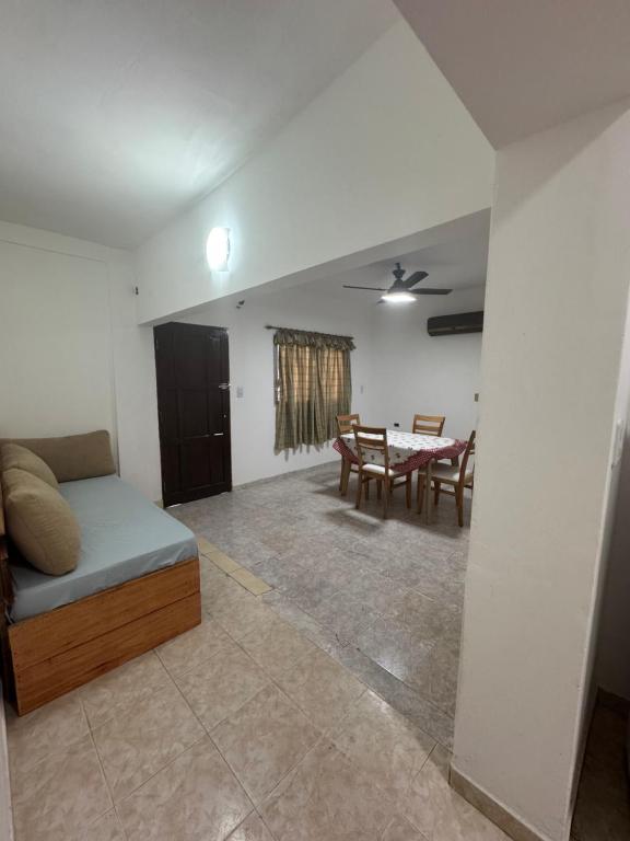a living room with a bed and a table at NEKZA TEMPORARIOSs in Resistencia