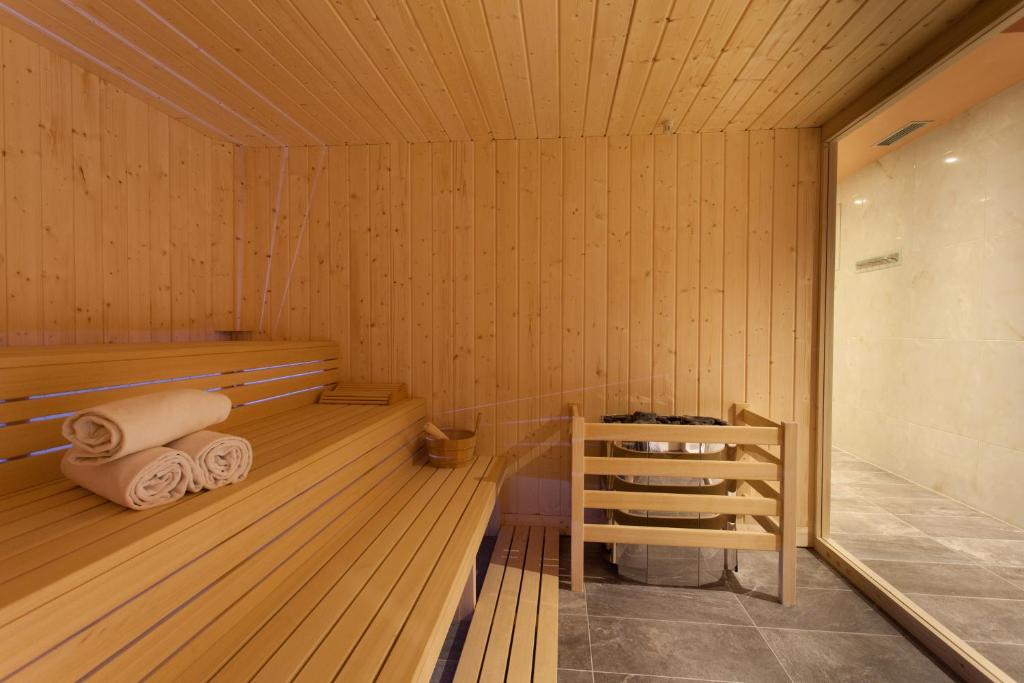 a sauna with wooden floors and a shelf and towels at Blue Waves Resort in Malinska