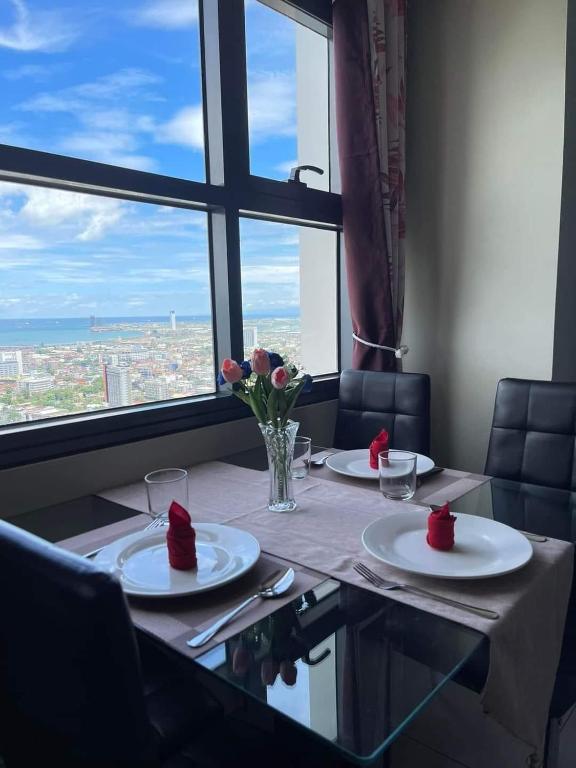 a table with plates and flowers on top of it at MaehwensStaycation in Cebu City