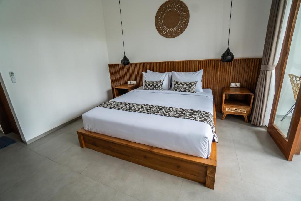 Postel nebo postele na pokoji v ubytování Kemari Ubud