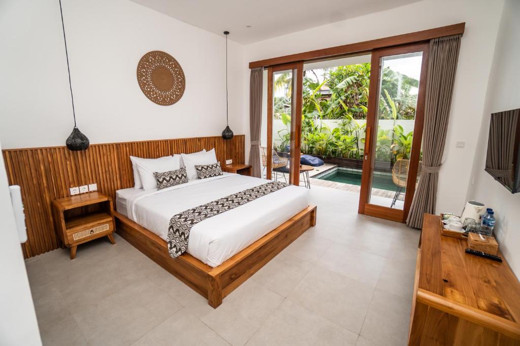 Postel nebo postele na pokoji v ubytování Kemari Ubud